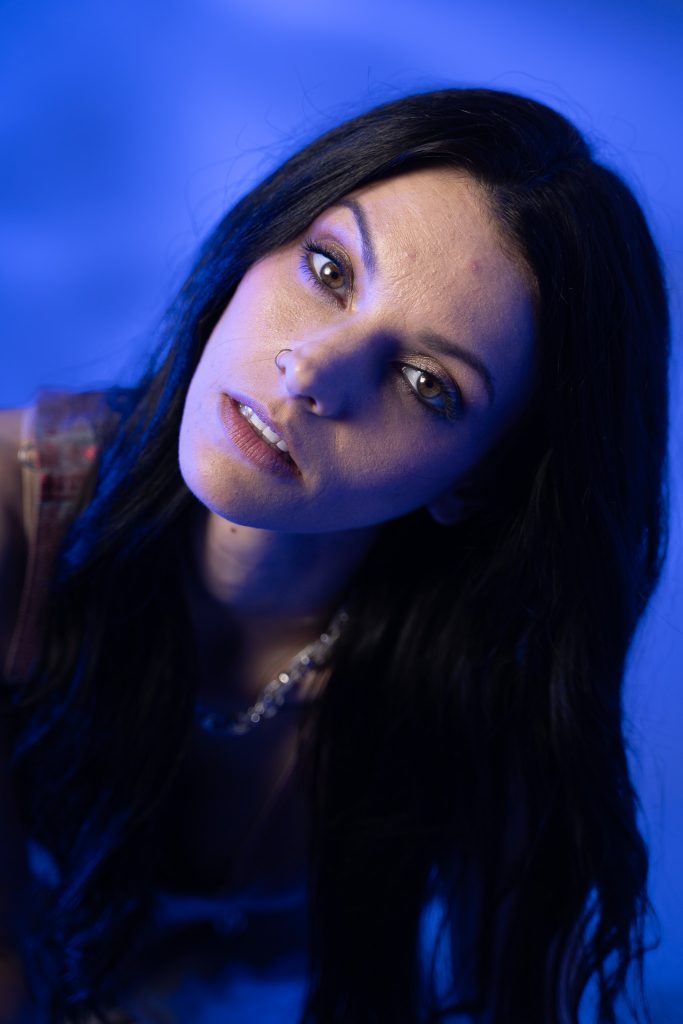 Close up creative light photo of a woman with a blue and white light background. Lyssa Benavidez Photography Elkhorn, NE Lyssab.com studio photography. 