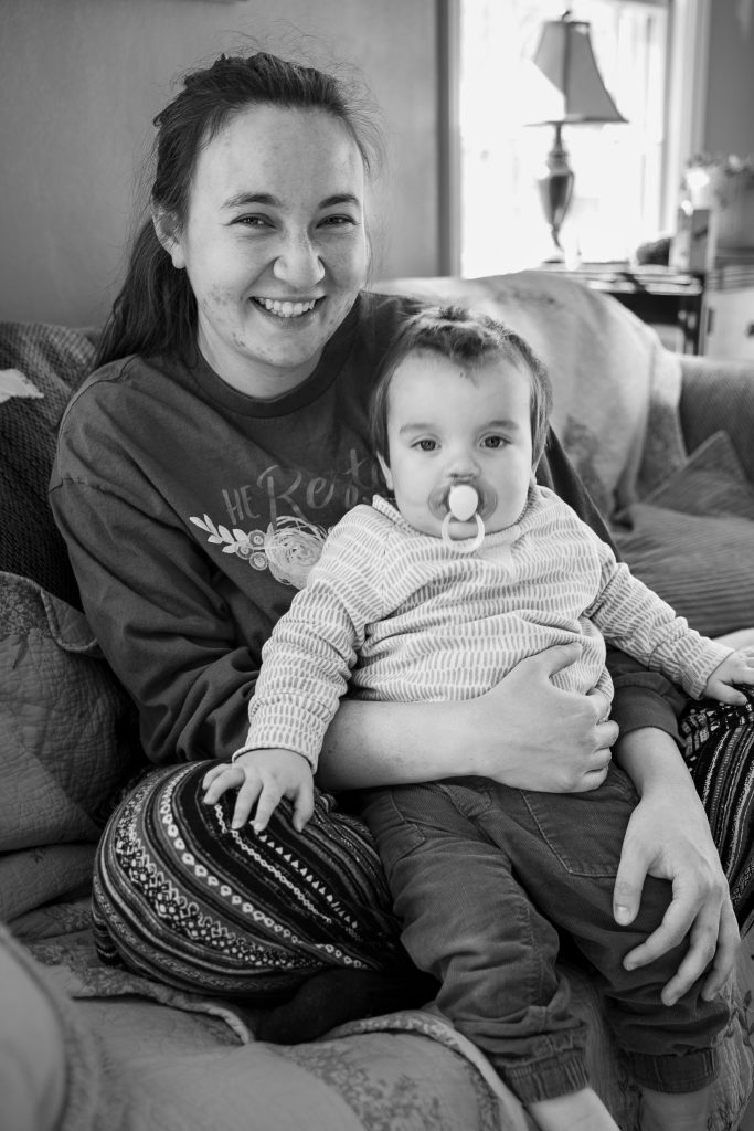 Black and white lifestyle portrait of a little boy and his mom sitting on a couch together. Lyssa Benavidez Photography Elkhorn, NE Lyssab.com lifestyle family photography. 