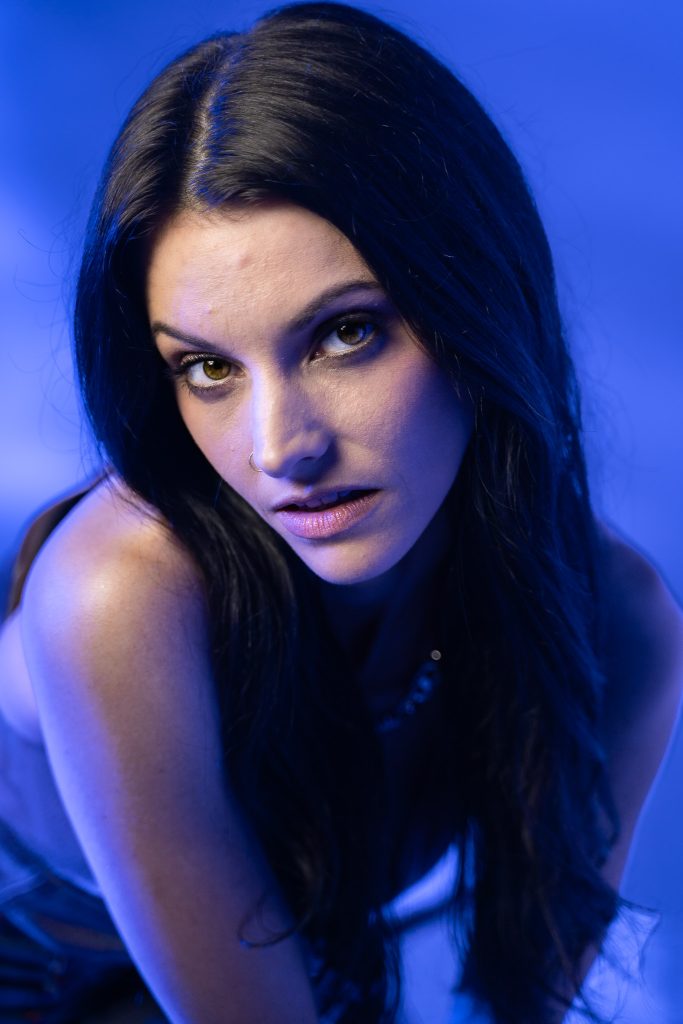 Close up creative light photo of a woman with a blue and white light background. Lyssa Benavidez Photography Elkhorn, NE Lyssab.com studio photography. 